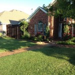 Entry to Home with Raised Flower Beds, Pathway and Sod